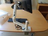a computer monitor on a desk with a keyboard and mouse