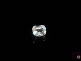 a close up of a white diamond on a black surface