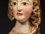 an image of a busturine of a woman wearing a bonnet