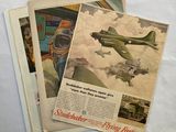 two old advertisements of airplanes are displayed on a white sheet