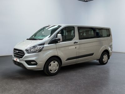 the white van is parked in a large room with a black floor