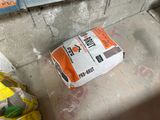 a bag of cement sitting on the floor in the corner of a room