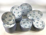 a lot of blue and white plates stacked on top of each other
