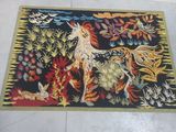 a rug with a picture of a unicorn and other animals on it