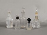 five glass bottles that are lined up on a table