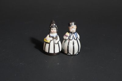 pair of salt and pepper shakers in black and white striped gowns