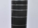 a large black vase sitting on a stand on a white surface