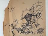 a piece of paper with drawings on it on the wall