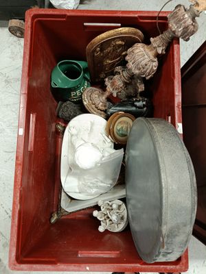 a red box filled with assorted items sitting on the floor