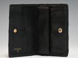 a chanel black leather wallet with gold hardware