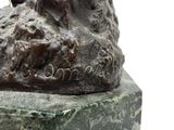 a statue of a man riding a horse on a rock