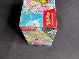 a box of pokemon cards on a table with a price tag