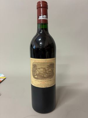 the bottle of red wine is sitting on the table