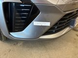 a close up of the front of a silver car