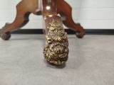 a wooden table with a gold decoration on it