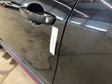 a close up of a car door handle with a sticker on it