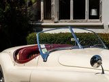 a white and red sports car parked in front of a house