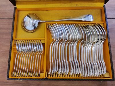 a lot of silverware in a box on a table