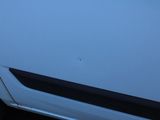 a close up of a car door handle with a sticker on it