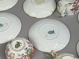 many cups and saucers sitting on a table