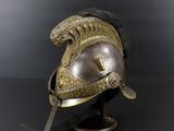 an antique helmet on a stand on a black background