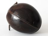 a black object on a white surface with a white background