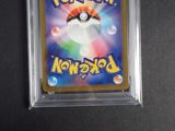 a close up of a pokemon trading card in a plastic case