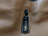 an image of a handbag with a keychain attached to it
