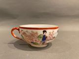 a close up of a cup with a woman on it on a table