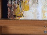 a picture of a painting on a easel with a name on it