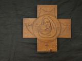 wooden cross with a carved image of the virgin mary and child jesus