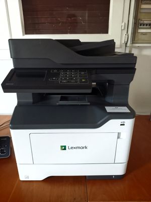 a close up of a printer on a wooden table