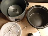 several pots and pans are sitting on a wooden table