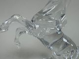 a glass horse that is standing on its hind legs