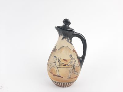 a small vase with a painting on it on a white surface
