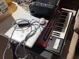 a keyboard and a laptop on a table in a room
