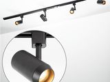 a close up of a black track light on a white wall
