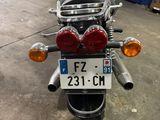 a motorcycle parked in a garage with a license plate on the back