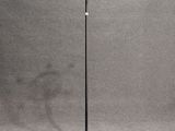 a black and gold coat stand with three coats on it