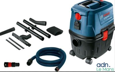 a blue vacuum cleaner with a hose and other tools