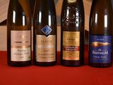 several bottles of wine are lined up on a red table