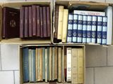 many books that are in a box on the floor