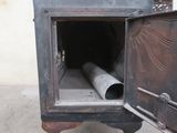 an old stove with a pipe sticking out of it