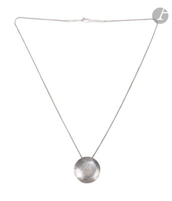 a necklace with a silver disc on a silver chain