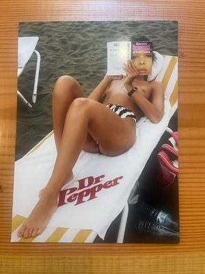 a picture of a woman in a bikini laying on a beach chair