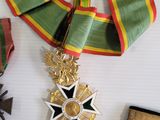 several medals and ribbons are arranged on a white surface