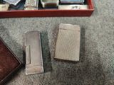 two lighters that are sitting on the floor next to each other
