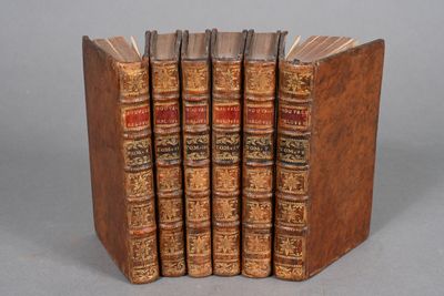 four books are stacked on top of each other on a table