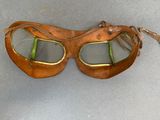 two pairs of goggles sitting on a table next to a pair of shoes