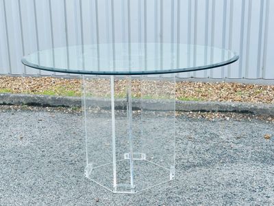 an image of a clear glass table with a metal base